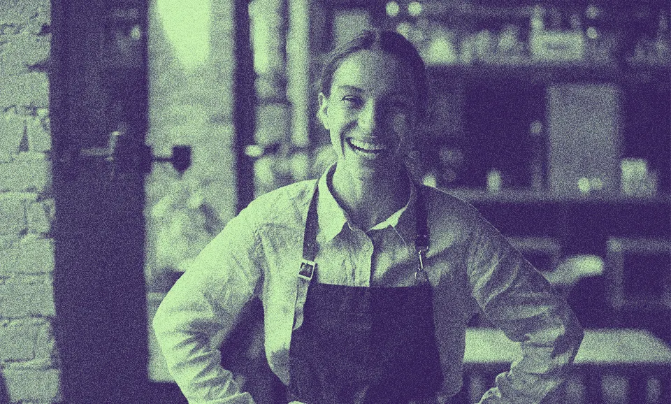 An PERM Green Card worker with an apron at work, smiling.